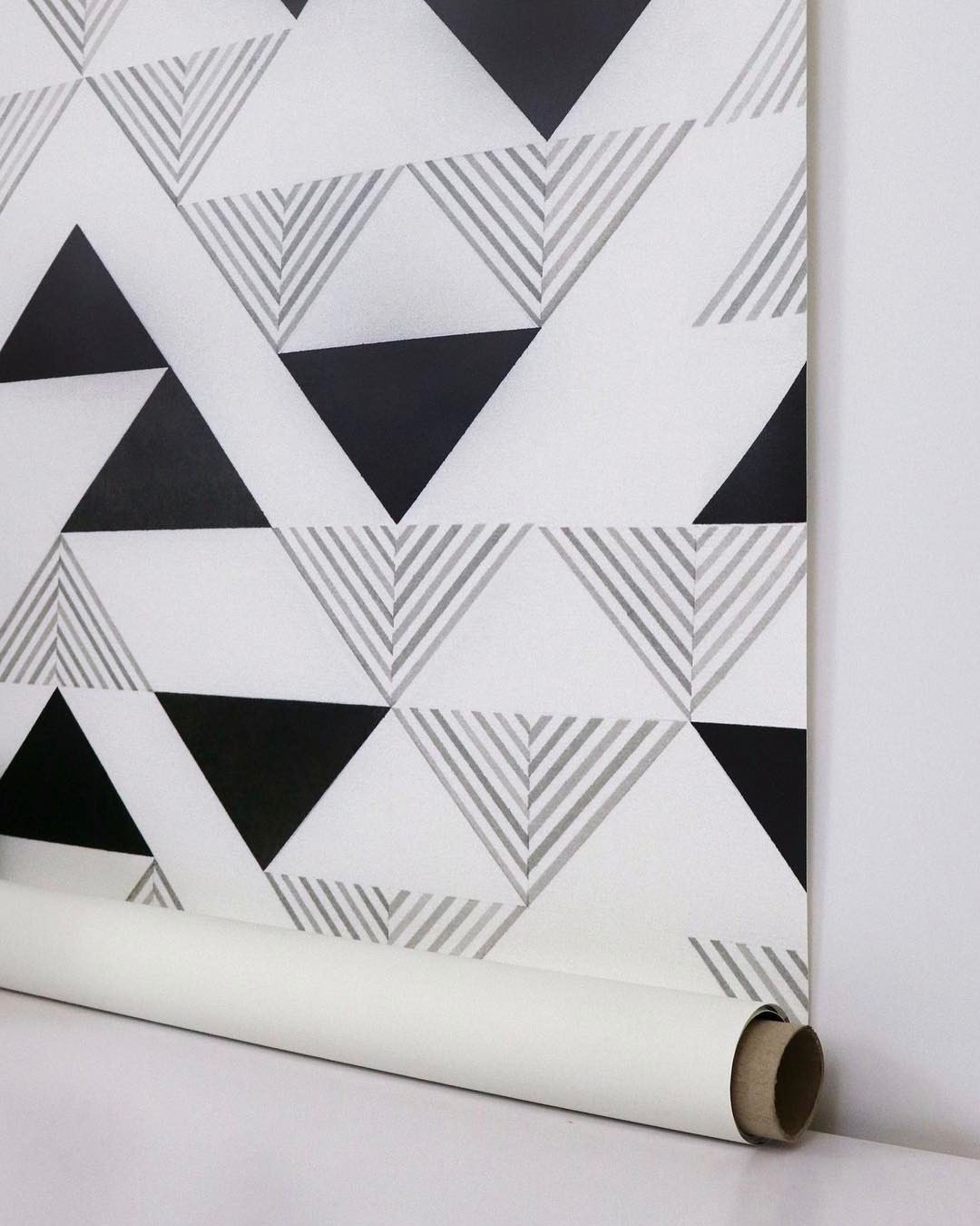 Printed fabric with a triangle pattern on a roll.