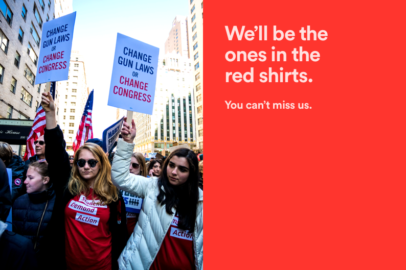 Moms Demand Action volunteers protesting in the streets wearing their trademark red shirts with text next to the image that reads: We'll be the ones in the red shirts. You can't miss us.
