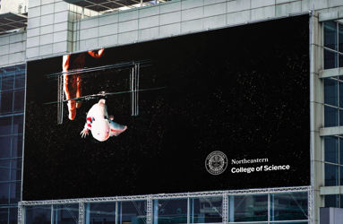 Billboard for Northeastern College of Science with Northeastern logo.