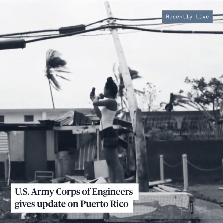 A woman takes a picture on her phone during in Puerto Rico during Hurricane Maria.