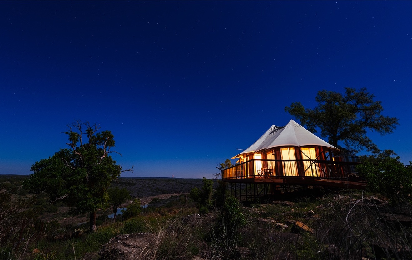 Luxury tent under night sky.